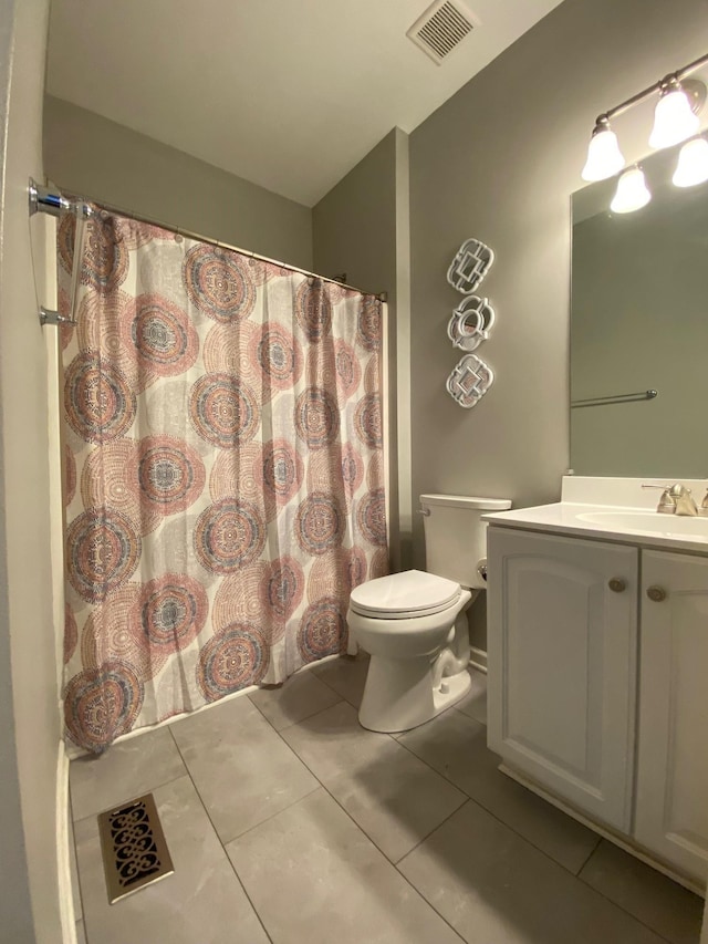 bathroom featuring tile patterned floors, vanity, and toilet