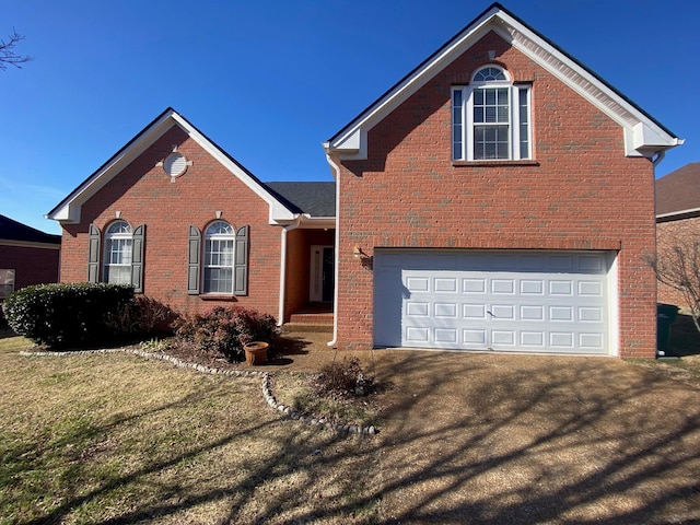 view of front property with a garage and a front yard