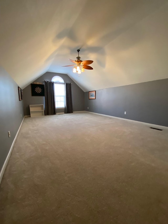 additional living space featuring ceiling fan, lofted ceiling, and carpet floors