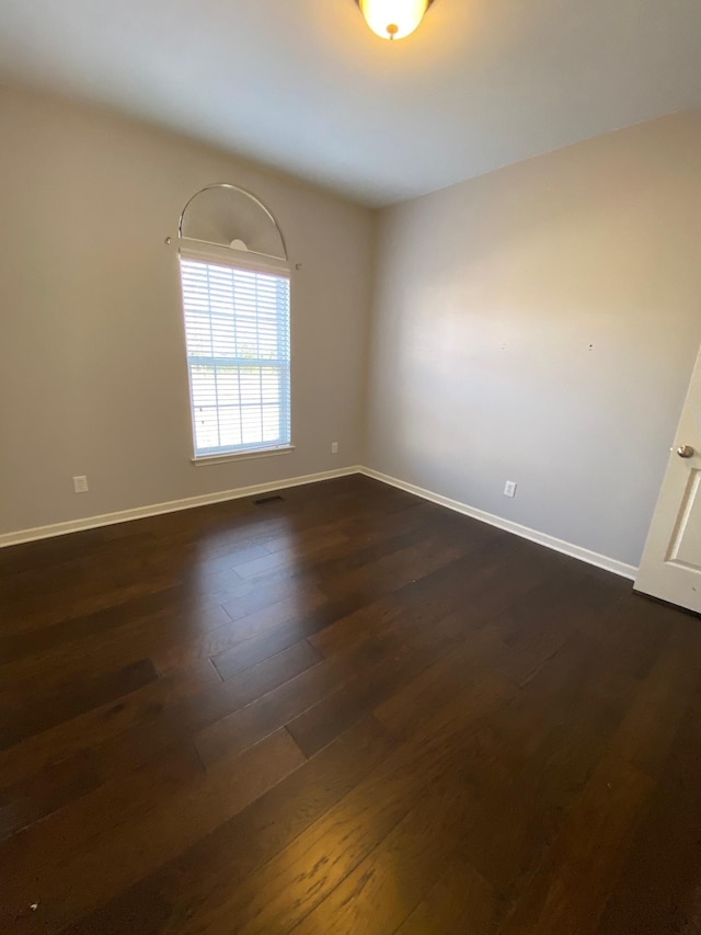 spare room featuring dark hardwood / wood-style floors