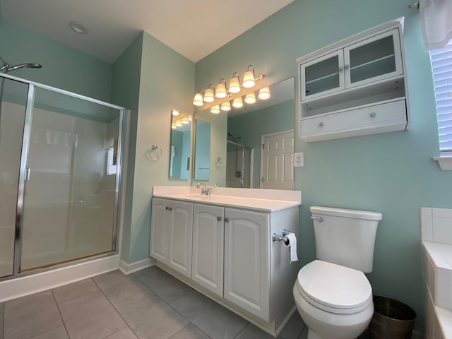 bathroom featuring vanity, tile patterned flooring, a shower with shower door, and toilet