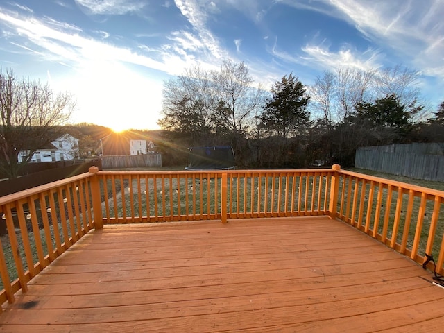 deck at dusk with a trampoline