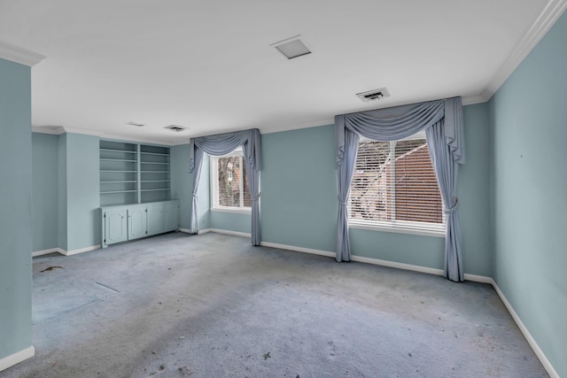 empty room with crown molding and light carpet