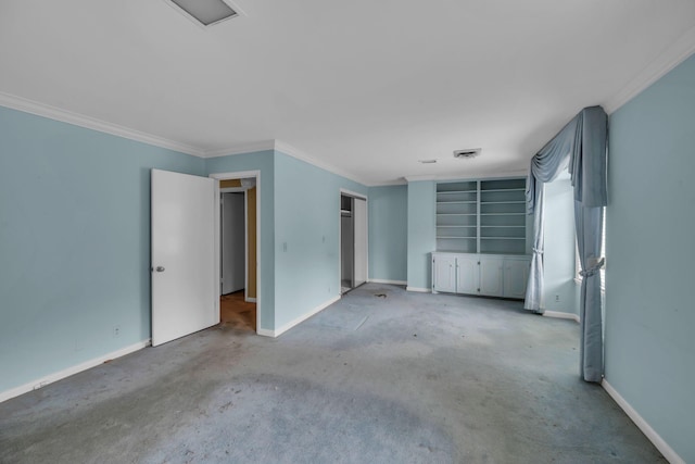 carpeted spare room featuring crown molding