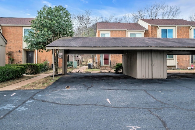 view of front of home featuring cooling unit and a carport