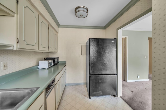 kitchen with ornamental molding, black fridge, and cream cabinets