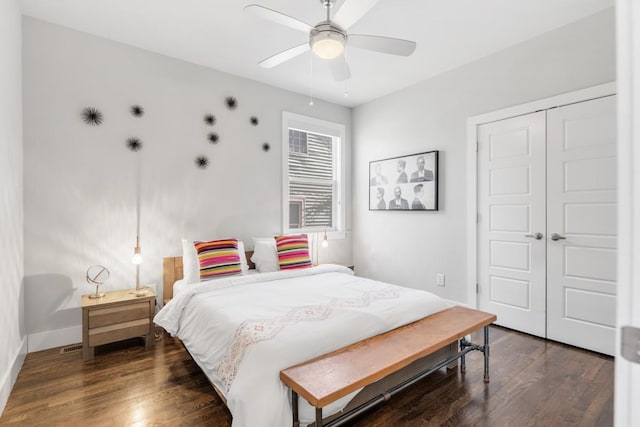 bedroom with dark hardwood / wood-style flooring, a closet, and ceiling fan