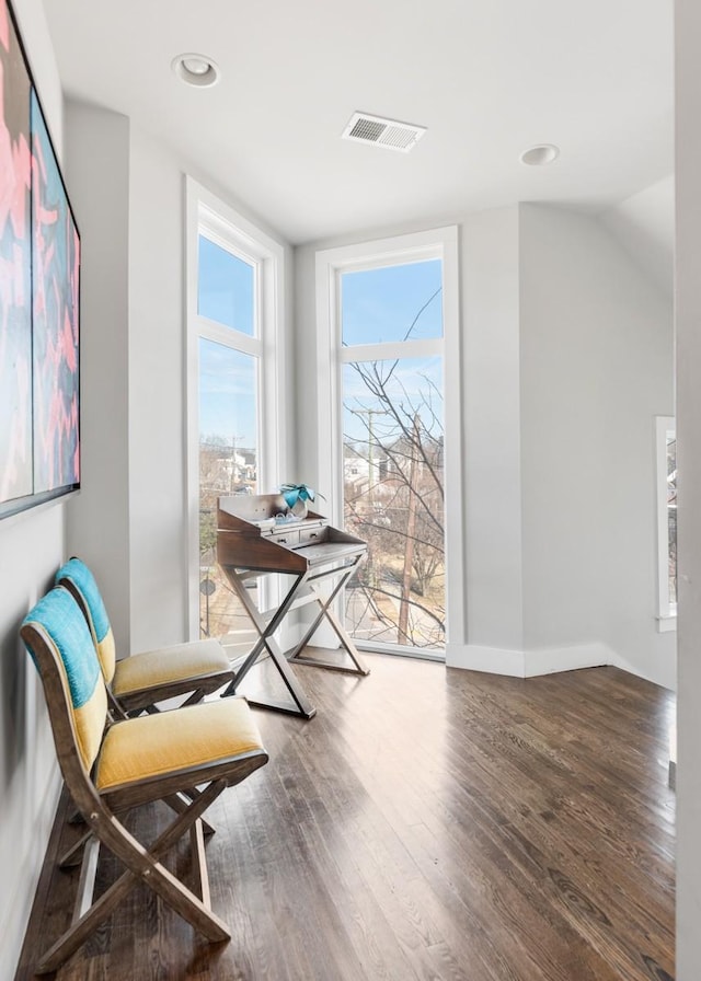 sitting room featuring wood-type flooring, vaulted ceiling, and floor to ceiling windows