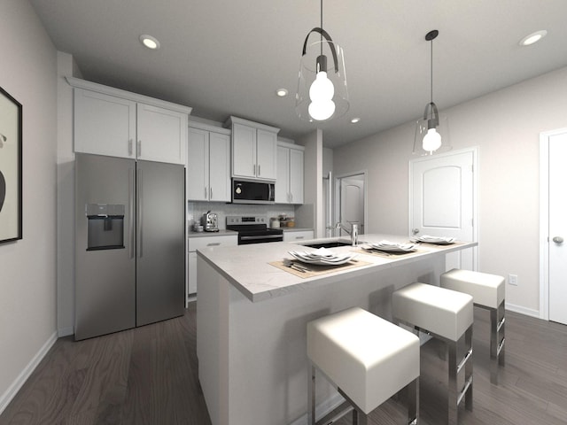 kitchen with sink, hanging light fixtures, an island with sink, stainless steel appliances, and white cabinets