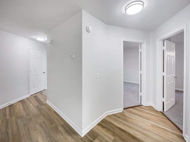 hall with wood-type flooring