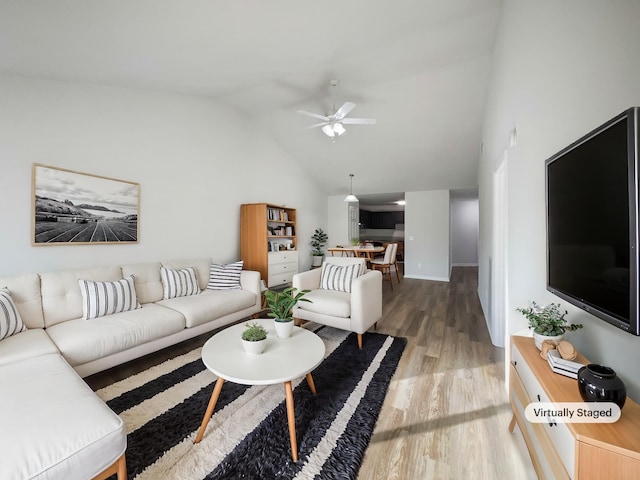 living room featuring wood-type flooring, high vaulted ceiling, and ceiling fan