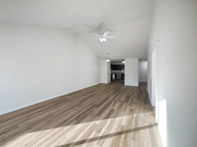 unfurnished living room with ceiling fan, wood-type flooring, and vaulted ceiling