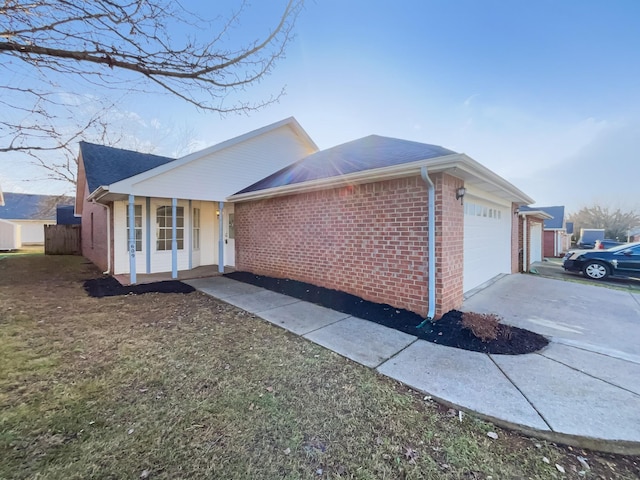 view of side of home with a garage and a porch