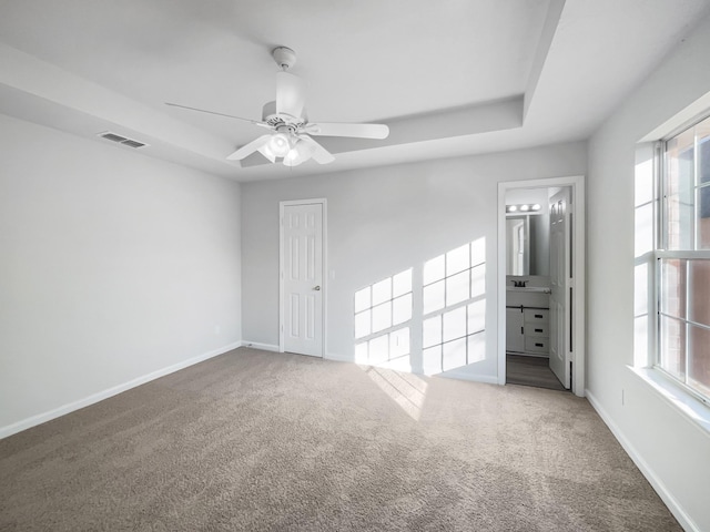 carpeted empty room featuring sink and ceiling fan