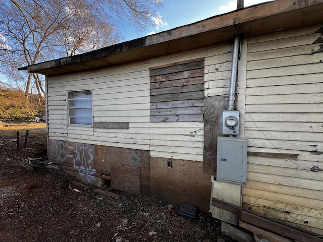 view of side of home featuring electric panel