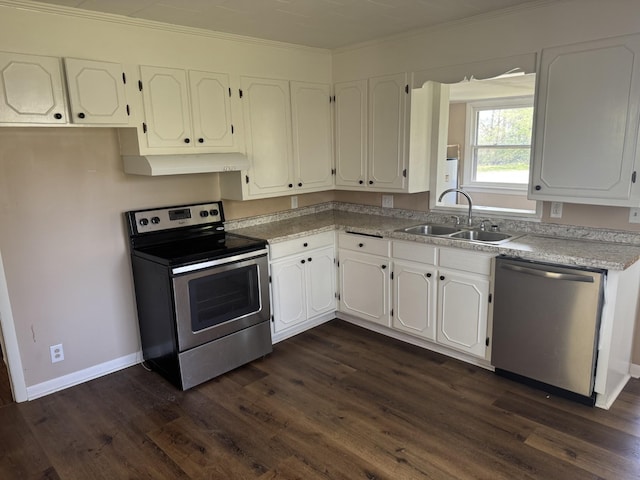 kitchen featuring dark wood-style flooring, white cabinets, under cabinet range hood, stainless steel appliances, and a sink