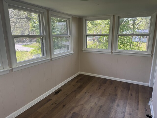 unfurnished sunroom featuring visible vents and a healthy amount of sunlight
