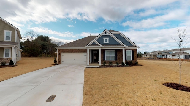 craftsman inspired home featuring a garage and a front lawn