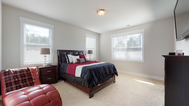 carpeted bedroom with multiple windows