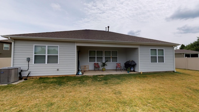 rear view of house with a patio, a yard, and cooling unit