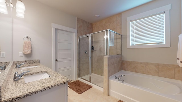 bathroom featuring vanity and independent shower and bath