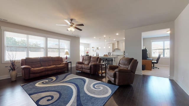 living room with ceiling fan and dark hardwood / wood-style floors