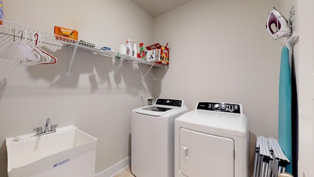 washroom featuring sink and independent washer and dryer