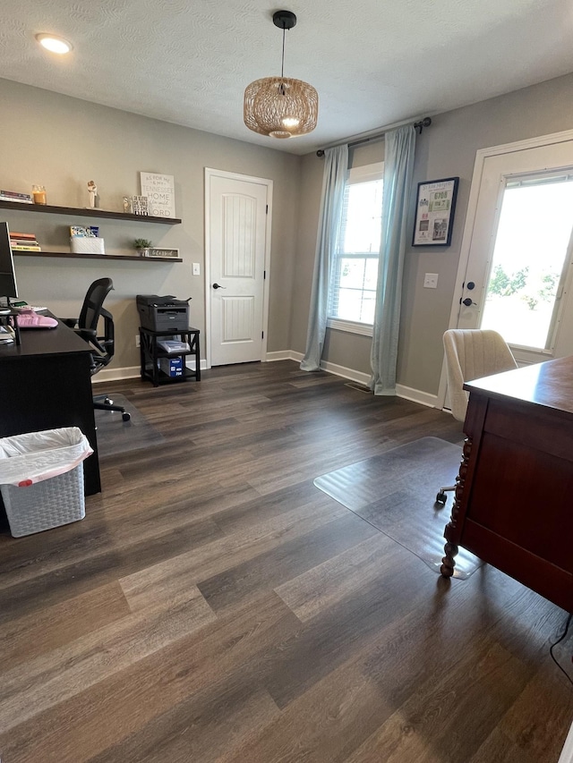 office space featuring dark wood-type flooring and a textured ceiling