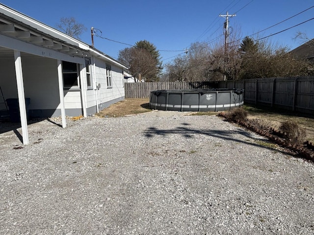 view of yard with a covered pool