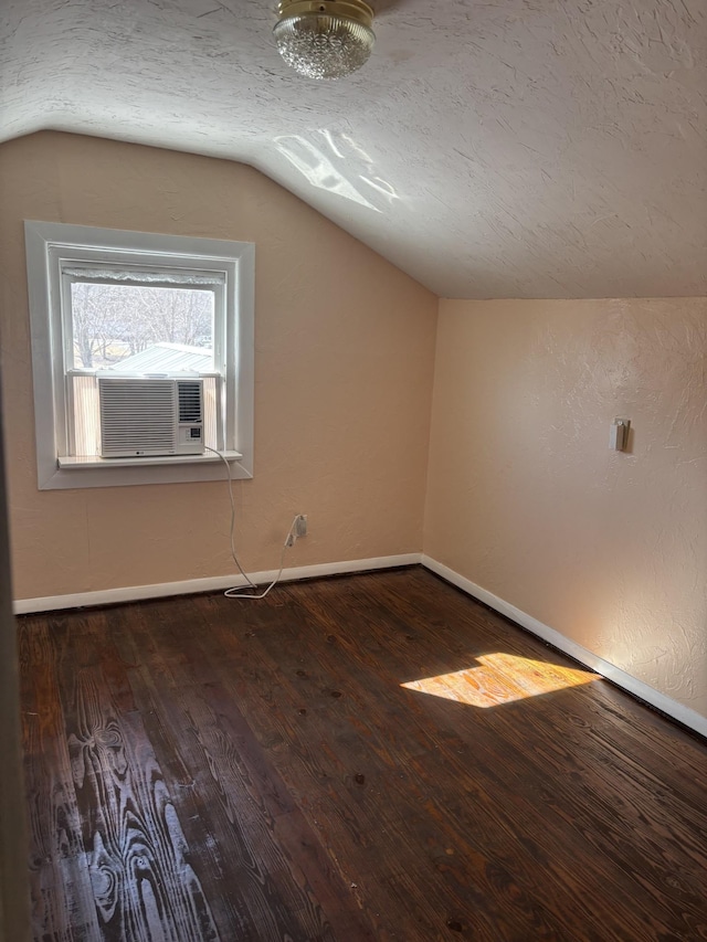 bonus room with lofted ceiling, dark hardwood / wood-style flooring, and a textured ceiling