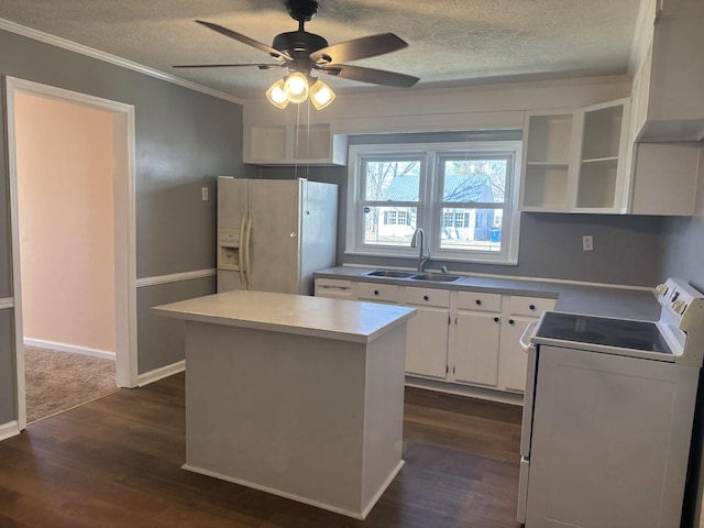 kitchen with sink, white appliances, white cabinetry, dark hardwood / wood-style floors, and a kitchen island