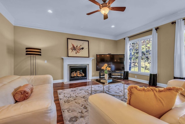 living room with crown molding, ceiling fan, and dark hardwood / wood-style flooring