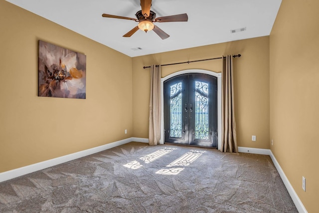 entrance foyer with french doors, ceiling fan, and carpet flooring