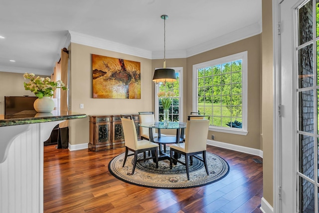 dining area featuring crown molding and dark wood-type flooring