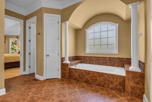 bathroom featuring decorative columns, ornamental molding, tile patterned flooring, and tiled bath