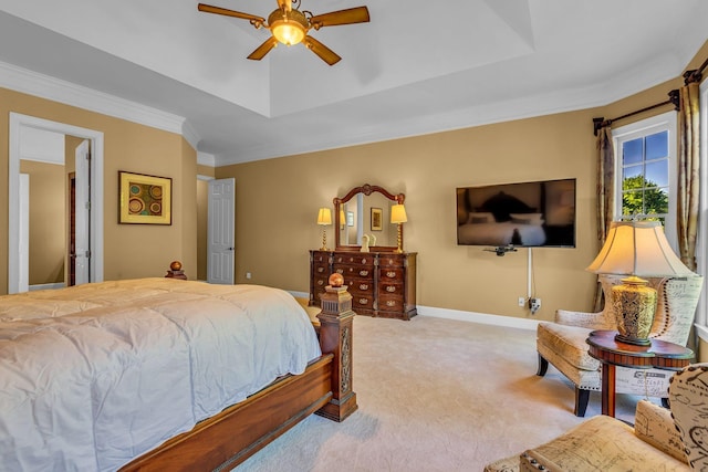 bedroom with crown molding, light colored carpet, and a tray ceiling