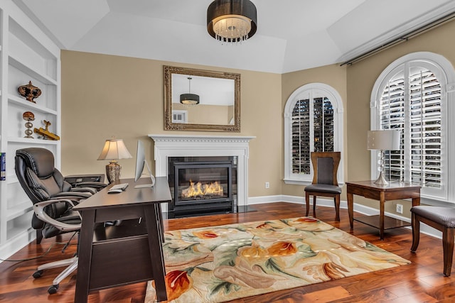 living area featuring wood-type flooring, built in features, and vaulted ceiling