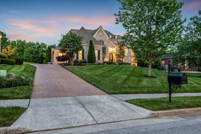 french provincial home featuring a yard