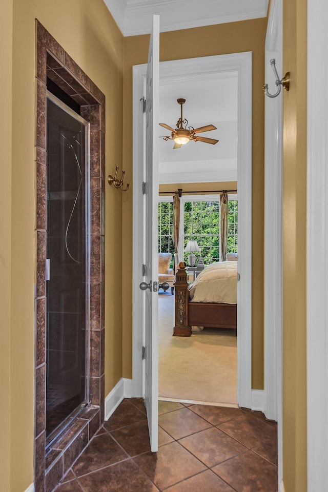 interior space with ornamental molding and dark tile patterned floors