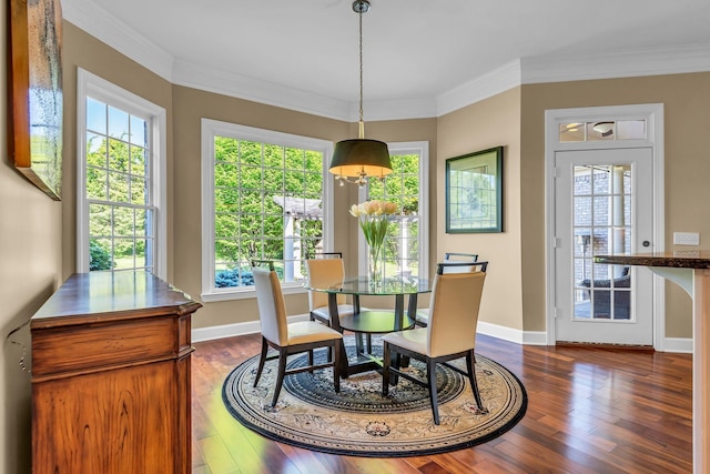 dining space with dark hardwood / wood-style flooring and ornamental molding