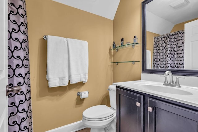 bathroom with vaulted ceiling, vanity, and toilet