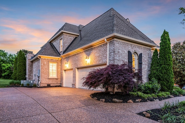 french country style house with a garage and central air condition unit