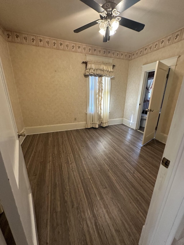 spare room featuring ceiling fan and dark hardwood / wood-style flooring