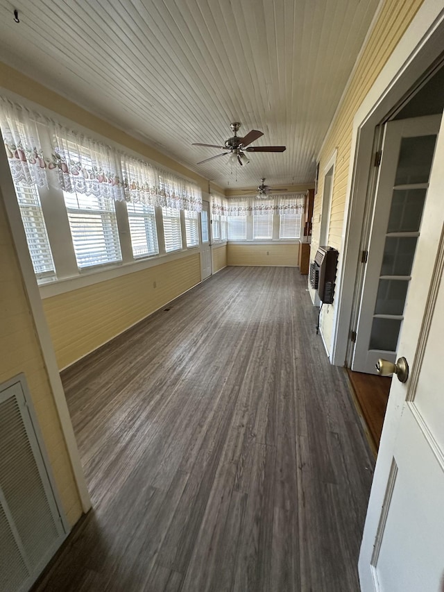 unfurnished sunroom with heating unit, wood ceiling, and ceiling fan