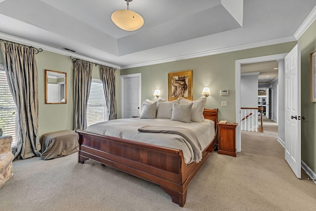 carpeted bedroom featuring a raised ceiling, crown molding, and multiple windows