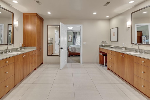 bathroom with tile patterned floors and vanity