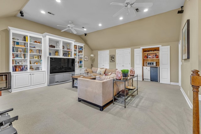 carpeted living room with vaulted ceiling and ceiling fan