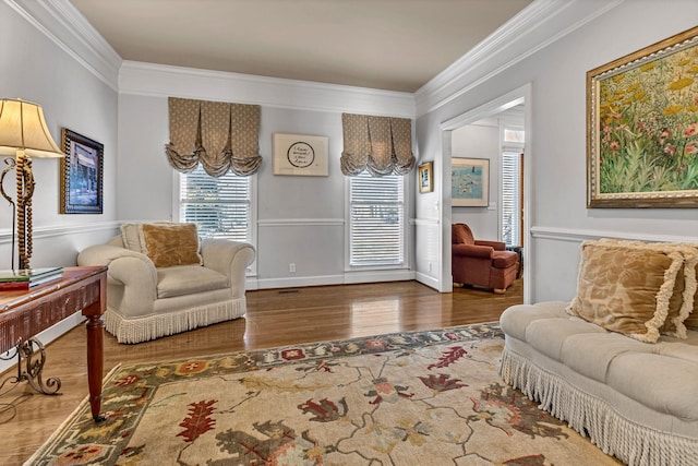 living room featuring hardwood / wood-style flooring and ornamental molding