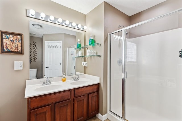 bathroom with vanity, toilet, and an enclosed shower