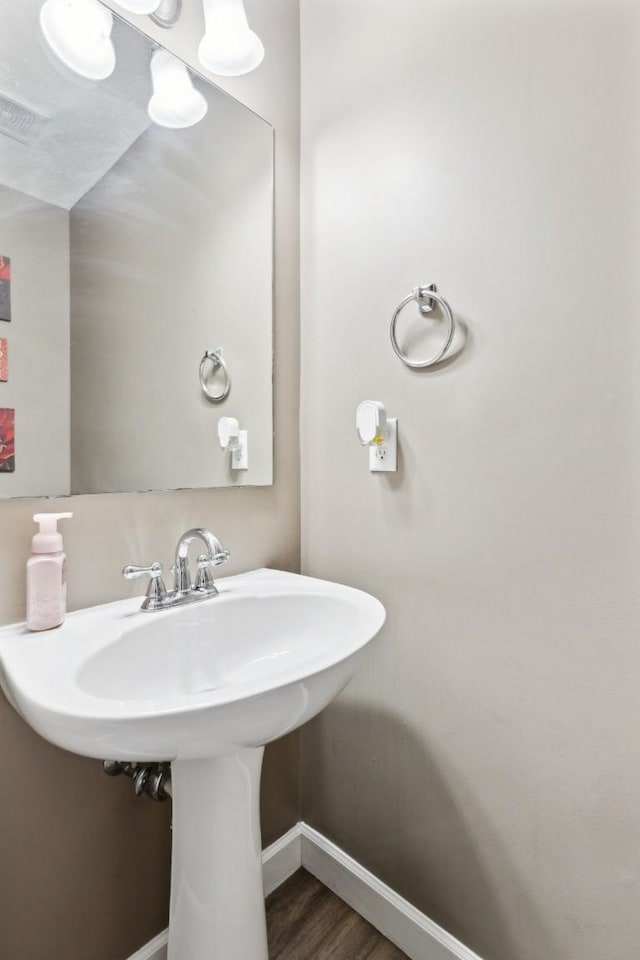 bathroom with hardwood / wood-style floors